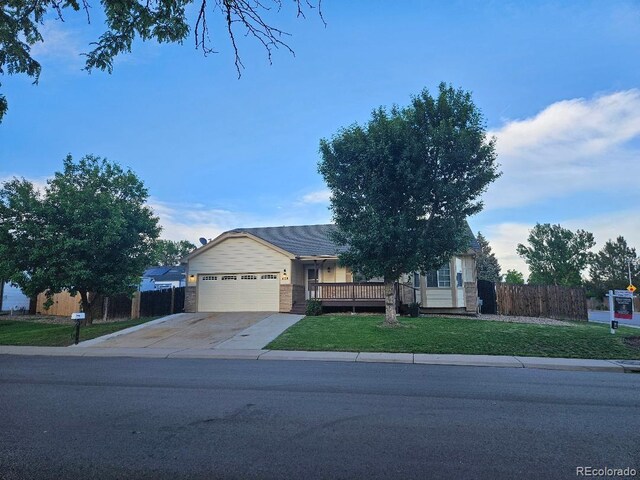 808 Idalia St, Aurora, CO 80011 - ranch-style house with a garage, concrete driveway, and a porch
