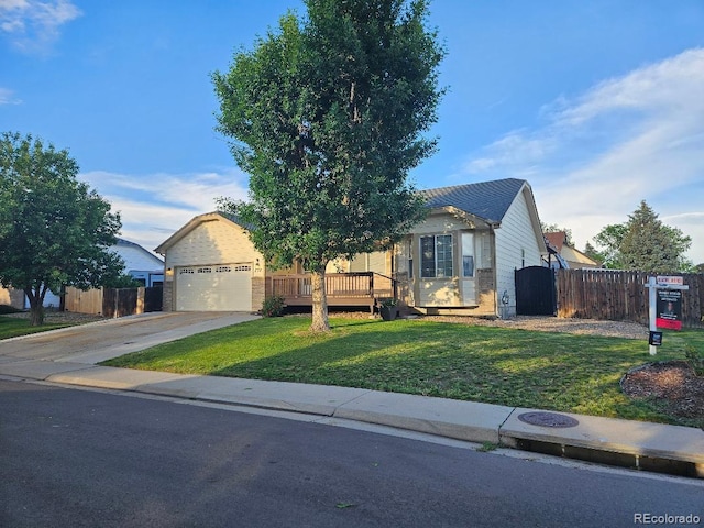 808 Idalia St, Aurora, CO 80011 - view of front of home featuring brick siding, concrete driveway, a wooden deck, and an attached garage