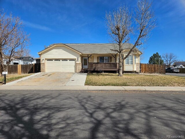 808 Idalia St, Aurora, CO 80011 - ranch-style house featuring a garage, concrete driveway, and covered porch