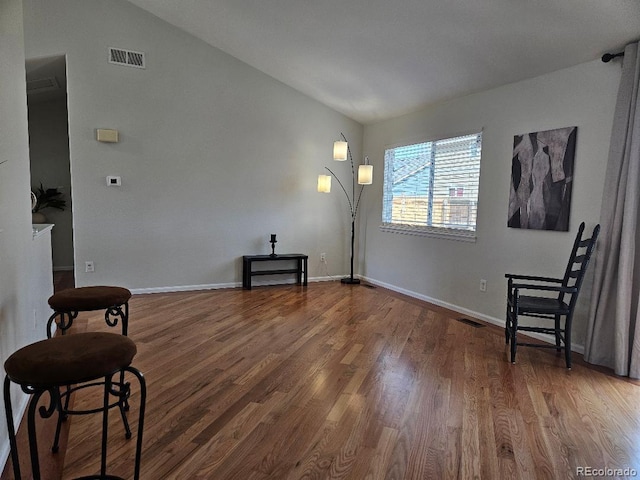 808 Idalia St, Aurora, CO 80011 - sitting room with lofted ceiling and wood finished floors