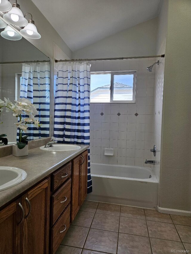 808 Idalia St, Aurora, CO 80011 - full bathroom featuring vaulted ceiling, shower / tub combo with curtain, tile patterned floors, and double vanity