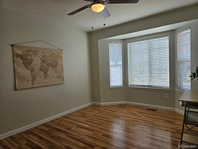 808 Idalia St, Aurora, CO 80011 - spare room featuring a ceiling fan, wood finished floors, and baseboards