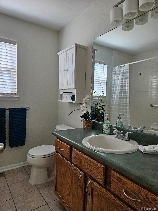 808 Idalia St, Aurora, CO 80011 - full bathroom featuring vanity, toilet, curtained shower, and tile patterned floors