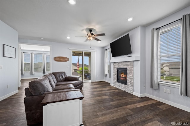 15604 Xenia Way, Brighton, CO 80602 - living room featuring ceiling fan, a stone fireplace, wood finished floors, recessed lighting, and baseboards