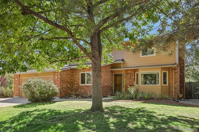 view of front of home with a front yard and a garage