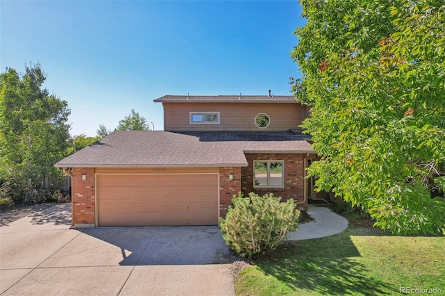 front facade with a front yard and a garage