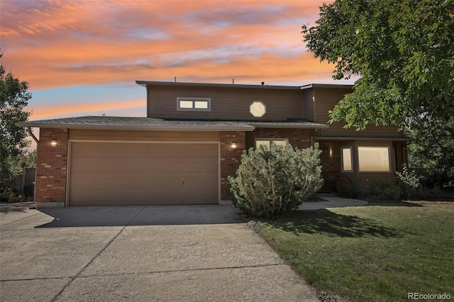 view of front of property featuring a garage and a yard