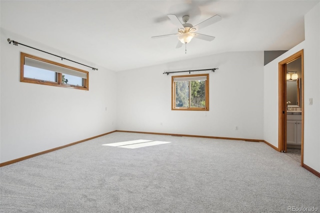 spare room with ceiling fan and light colored carpet