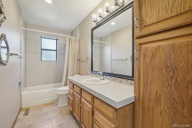 full bathroom with shower / tub combo with curtain, tile patterned floors, vanity, and toilet