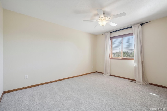 unfurnished room with ceiling fan and light colored carpet