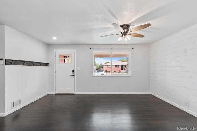 entryway featuring dark wood-type flooring, a textured ceiling, and ceiling fan