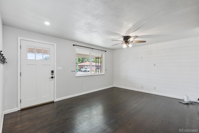 entryway featuring a textured ceiling, ceiling fan, and dark hardwood / wood-style flooring