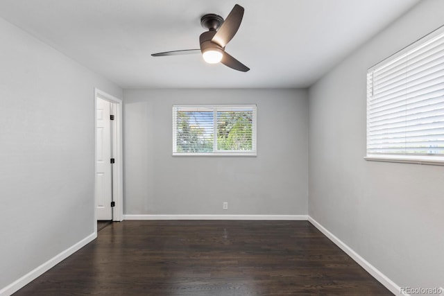 empty room with dark hardwood / wood-style floors and ceiling fan