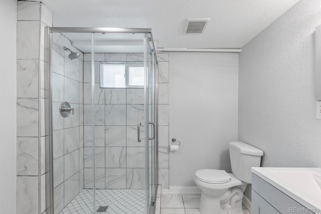 bathroom with vanity, a textured ceiling, toilet, and walk in shower