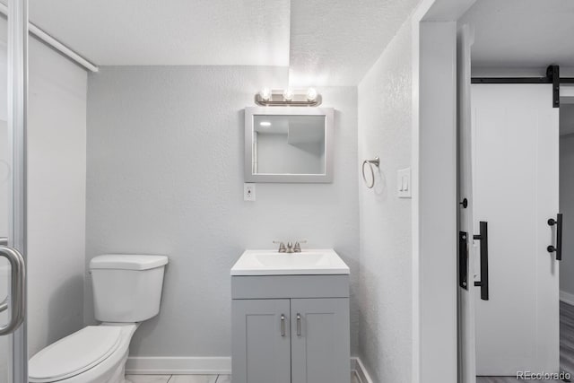 bathroom with vanity, a textured ceiling, toilet, and tile patterned floors