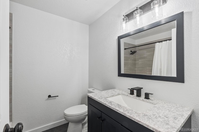 bathroom featuring toilet, a textured ceiling, a shower with curtain, and vanity