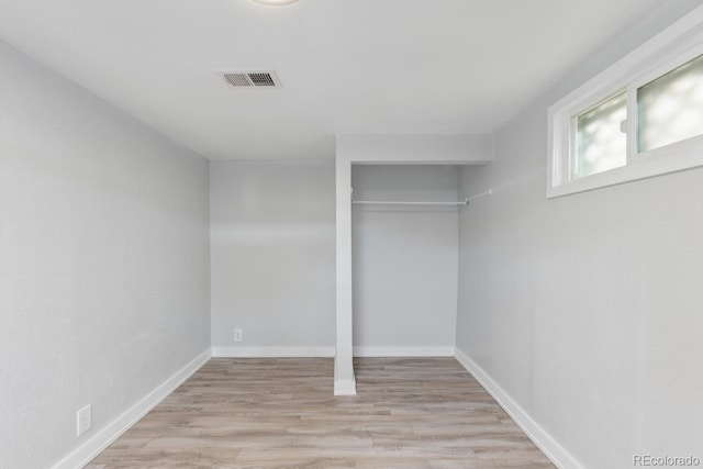 unfurnished bedroom featuring a closet and light wood-type flooring