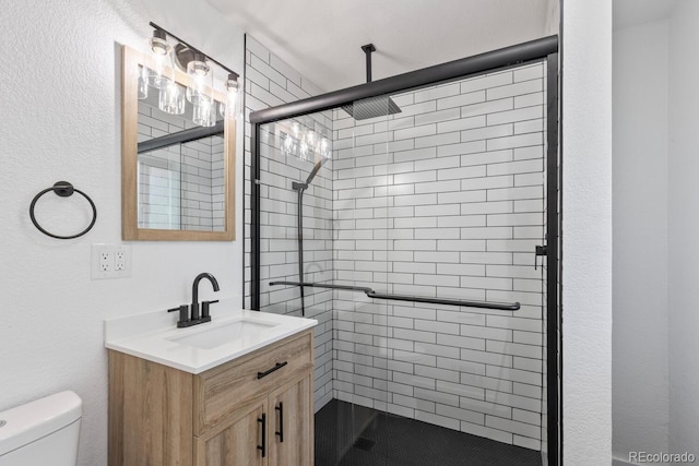 bathroom featuring vanity, toilet, and an enclosed shower