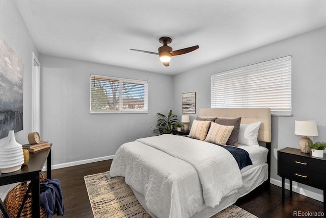 bedroom featuring dark wood-style flooring, a ceiling fan, and baseboards