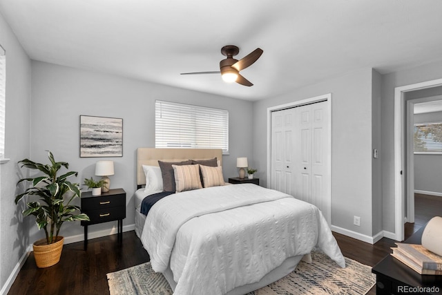 bedroom featuring ceiling fan, a closet, baseboards, and wood finished floors