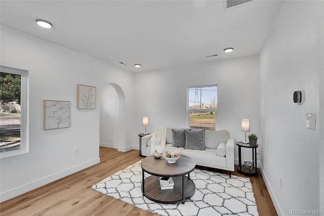 16130 Mt Vernon Rd, Golden, CO 80401 - living area with arched walkways, wood finished floors, baseboards, and recessed lighting