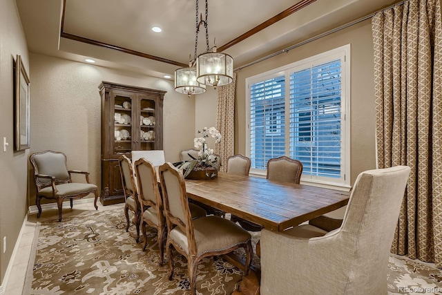 dining space with baseboards, a textured wall, a tray ceiling, crown molding, and recessed lighting