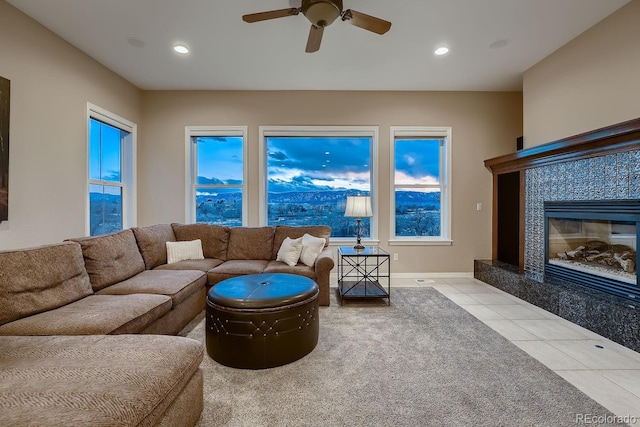 tiled living room featuring ceiling fan, a fireplace, baseboards, and recessed lighting