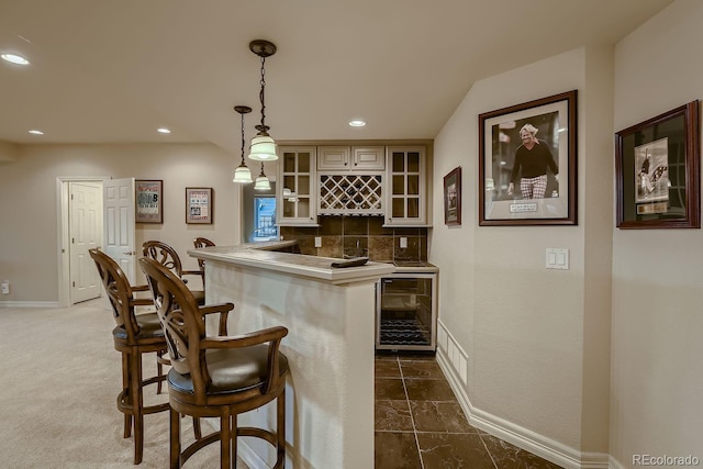 bar featuring wine cooler, recessed lighting, backsplash, wet bar, and decorative light fixtures