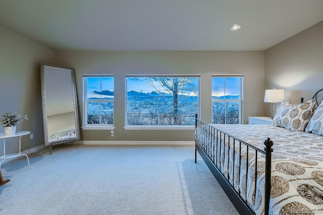 carpeted bedroom featuring baseboards