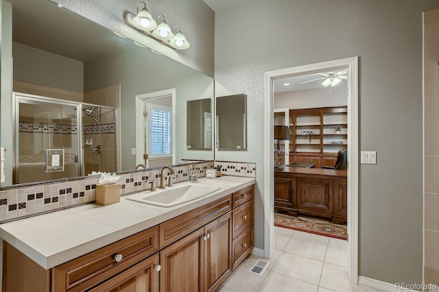 full bathroom with tile patterned flooring, vanity, visible vents, backsplash, and a shower stall