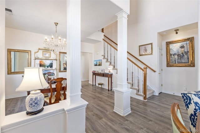 entryway with decorative columns and dark hardwood / wood-style flooring