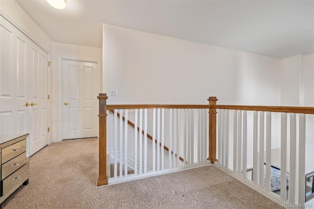 hall with light colored carpet