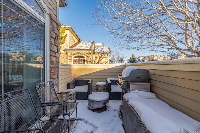 snow covered patio featuring an outdoor hangout area