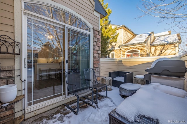 snow covered patio featuring a balcony