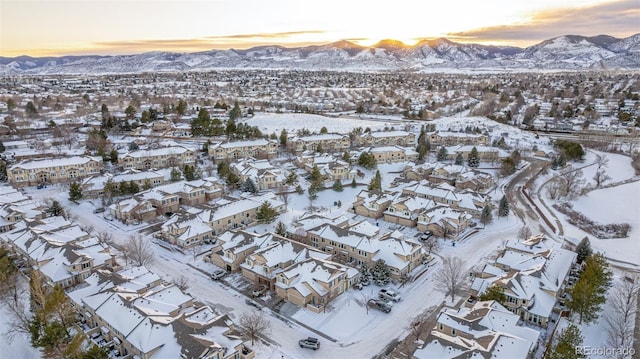 snowy aerial view with a mountain view