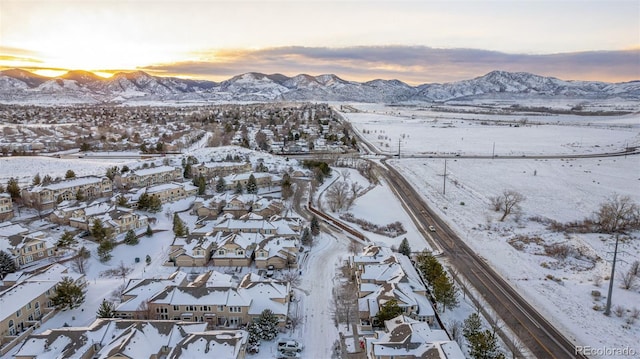 snowy aerial view with a mountain view