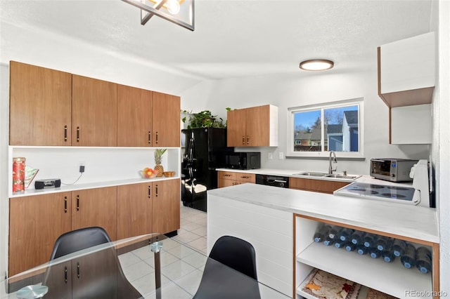 kitchen featuring sink, vaulted ceiling, black appliances, and light tile patterned flooring