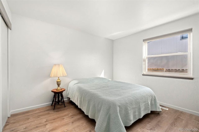 bedroom featuring hardwood / wood-style flooring and a closet