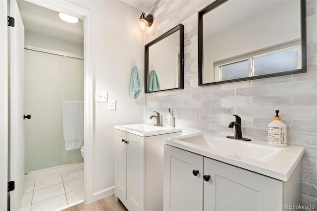 bathroom featuring vanity, backsplash, tile patterned flooring, and toilet