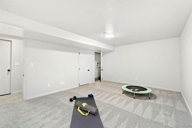 exercise room with light colored carpet