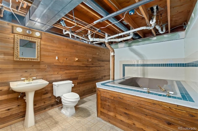 bathroom featuring wooden walls and toilet