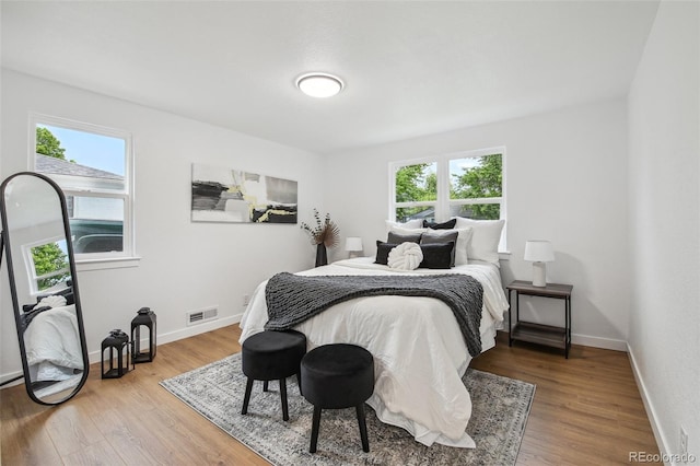 5515 Dudley Ct, Arvada, CO 80002 - bedroom featuring multiple windows, wood finished floors, and baseboards
