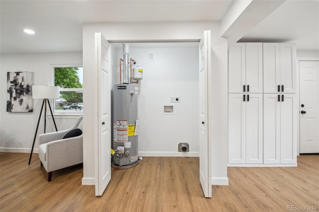 5515 Dudley Ct, Arvada, CO 80002 - washroom with hookup for an electric dryer, water heater, hookup for a washing machine, light wood-style floors, and recessed lighting