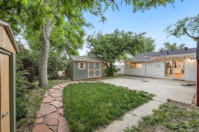5515 Dudley Ct, Arvada, CO 80002 - view of grassy yard featuring a patio area and a storage unit