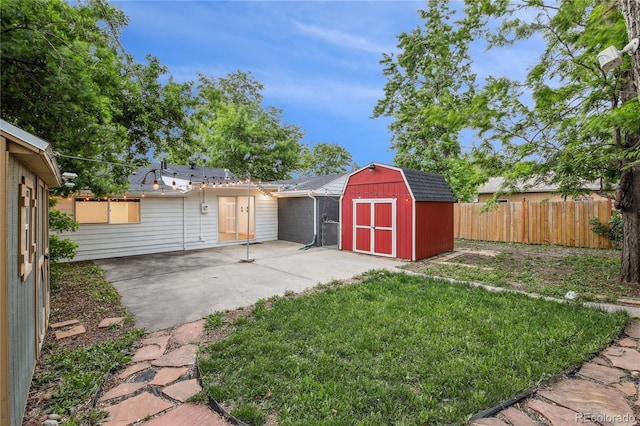 5515 Dudley Ct, Arvada, CO 80002 - fenced backyard with a patio area and a storage unit