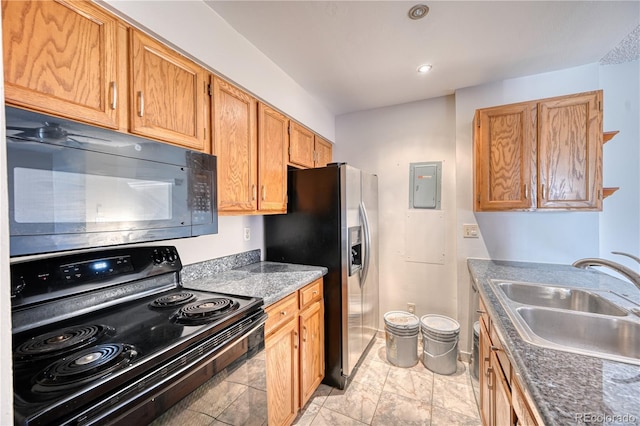 kitchen featuring black appliances, a sink, and electric panel