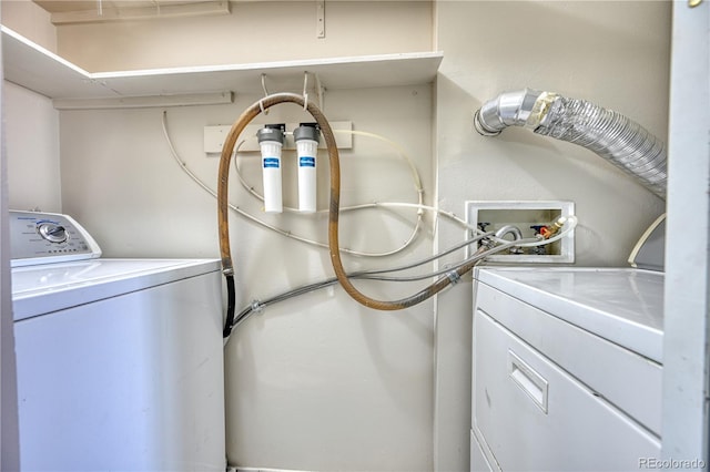 clothes washing area with washing machine and dryer