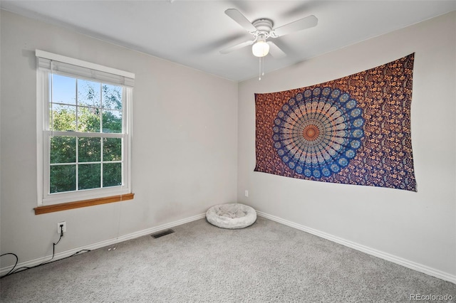 carpeted empty room featuring ceiling fan