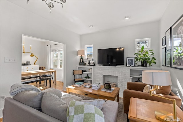 living room featuring wood-type flooring and a fireplace