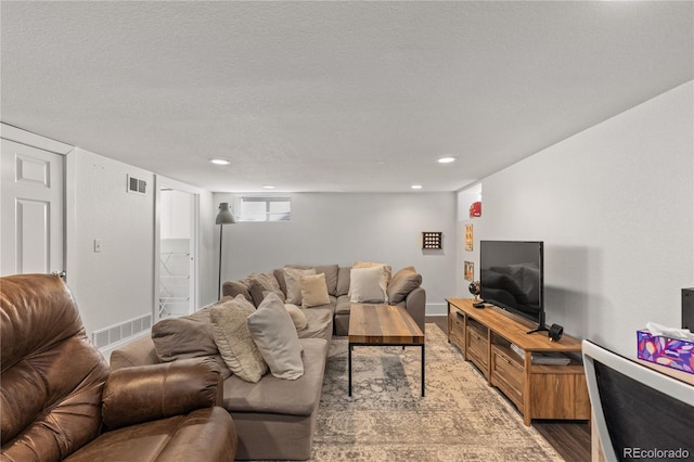 living room featuring hardwood / wood-style flooring and a textured ceiling